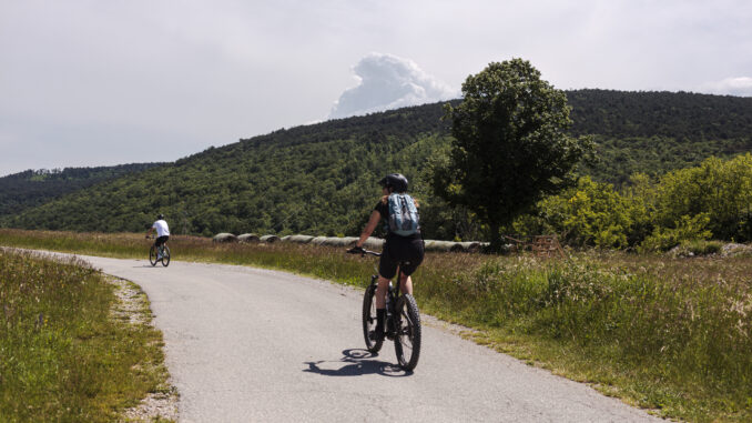 Two road cyclists, male and female on the road